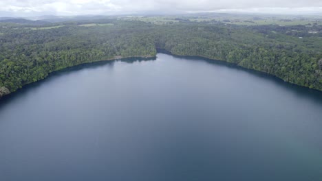 Lake-Eacham-With-Lush-Rainforest-In-Atherton-Tableland,-Queensland,-Australia---aerial-drone-shot