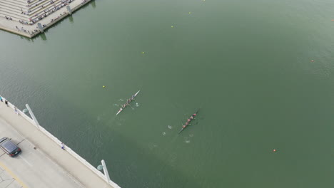 Aerial-footage-of-people-watching-a-rowing-race-on-the-Tennessee-River-in-Chattanooga,-TN