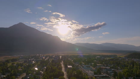 Aerial-of-Crested-Butte-with-sun-rising-over-the-mountain-panning-over-the-Colorado-mountain-town