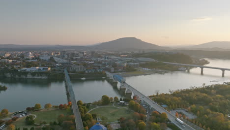Sped-up-aerial-footage-in-reverse-that-goes-across-the-Tennessee-River-and-showing-Lookout-Mountain-behind-downtown-Chattanooga,-TN