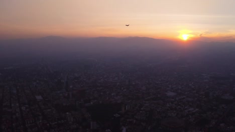 As-the-sun-touches-the-horizon,-a-commercial-flight-lands-into-Mexico-City