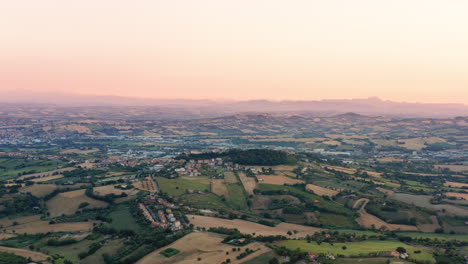 Aerial-drone-view-of-hills-and-agricultural-fields-in-Marche-region,-Italy