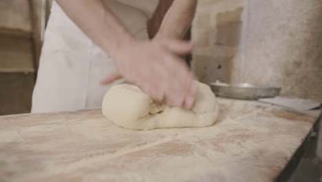 Slow-motion-footage-of-a-man-kneading-and-folding-focaccia-dough