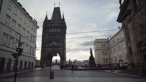 Old-Town-Bridge-Tower-in-Prague,-Czech-Republic,-gimbal-side-walking-wide-angle-view