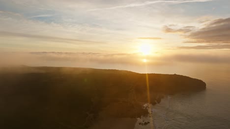 Drone-flying-through-atmospheric-mist-at-sunset