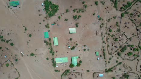 Desert-kenya,-africa-landscape-town-from-the-air-and-above-people-that-have-gathered-around-buildings