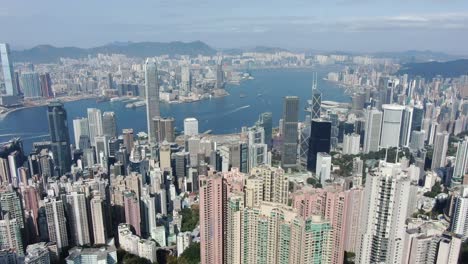 Fly-over-Hong-Kong-Victoria-bay-with-city-skyscrapers-on-a-beautiful-day