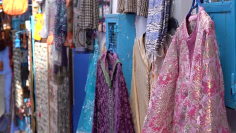 Local-clothes-sold-in-the-streets-of-the-Medina-in-Chefchaouen,-Morocco