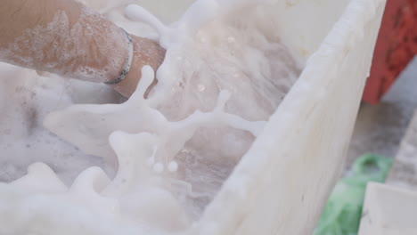 Slow-motion-footage-of-a-man-washing-an-octopus-in-soapy-water-off-the-coast-of-Italy