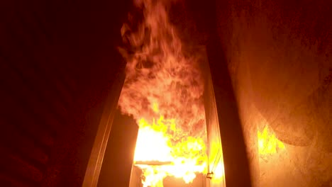 Fire-ignites-in-burn-building-and-flashover-on-ceiling-sends-flames-rolling-down-hallway-toward-camera