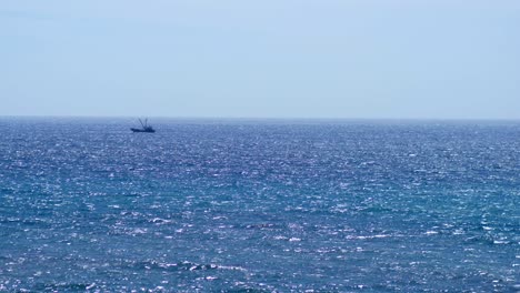 Kleines-Fischerboot,-Das-Durch-Wellen-Am-Horizont-Segelt