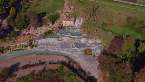 Saturnia-geothermal-sulfur-hot-spring-pools-in-Italy,-aerial