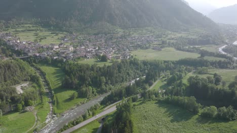 Aerial-view-of-Val-di-Fiemme-Village-in-idyllic-landscape-in-front-of-gigantic-dolomite-mountains
