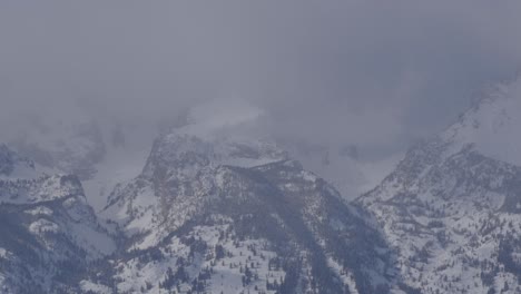 Tilting-telephone-shot-of-the-Grand-Teton-from-valley-to-cloud-covered-summit