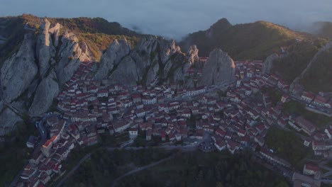 Pietrapertosa-mountain-town-in-Italy-during-golden-hour-morning,-aerial