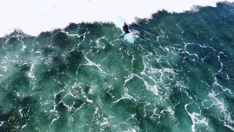 surfer-paddling-through-waves-in-carlsbad