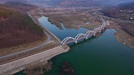 Aerial-View-Of-Railway-Arch-Bridge-Spanning-The-Skawa-River-Near-The-Zembrzyce-Village-in-Poland