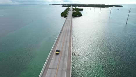 Yellow-car-driving-across-bridge-on-Florida-keys-overseas-highway