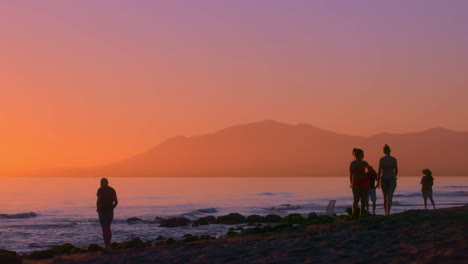 Silhouette-of-several-people-at-the-beach-during-sunset