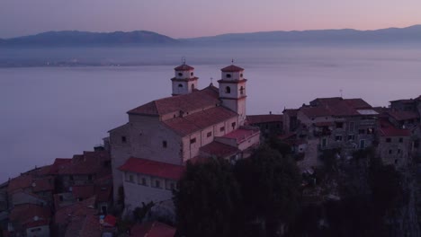 Chiesa-Santa-Croce-church-of-Artena-in-Monti-Lepini-mountains-with-mist-in-valley-at-sunrise