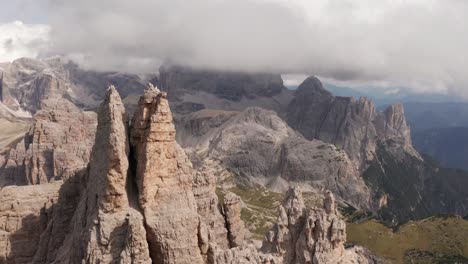 Aerial-moving-over-Tre-Cime-di-Lavaredo-mountains-with-low-clouds