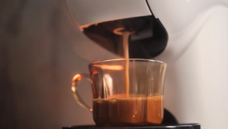 Process-of-making-espresso-coffee-by-coffee-machine-into-a-glass-cup