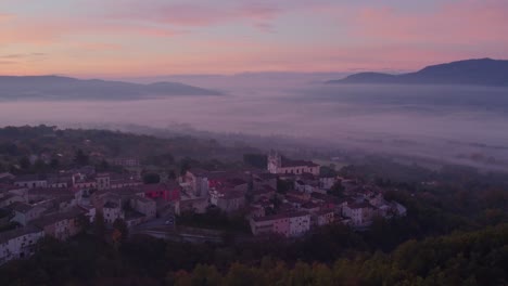 San-Giuliano-del-Sannio-town-with-magical-morning-mist-during-sunrise,-aerial