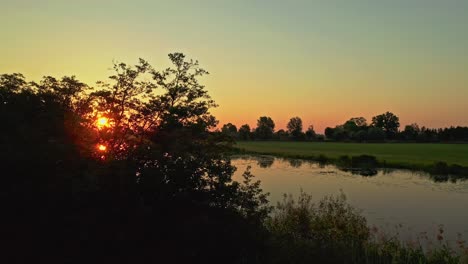 Sunrise-Reveal-Drone-Aerial-Shot-on-reflective-lake