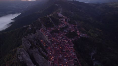 Pietrapertosa-mountain-village-early-morning-before-sunrise,-aerial