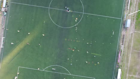 top-down-aerial-view-of-a-football-training-session-in-the-Buenos-Aires-club-at-sunset