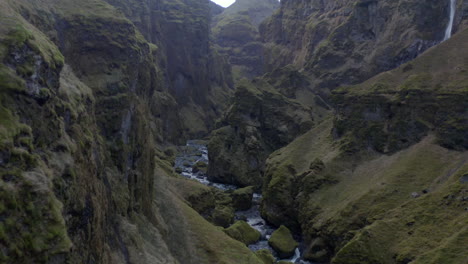 Low-aerial-shot-panning-up-through-Múlagljúfur-Canyon-Iceland