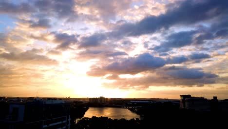 Fire-sunrise-colorful-cloudy-sky-and-sunbeams-at-Sydney-International-airport-skyline