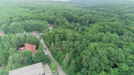 Drone-view-of-a-rural-community-in-the-mountains-covered-with-trees