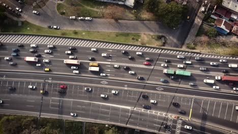 A-dynamic-aerial-shot-of-heavy-traffic-over-and-under-the-flyover