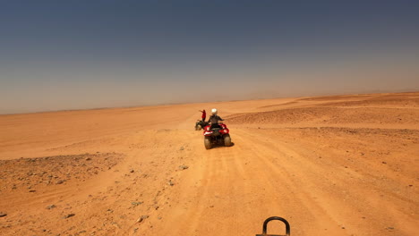 Quad-Bikes-Driving-at-Safari-Desert-in-Hurghada,-Egypt,-Off-Road-Trip,-Sandy-Terrain,-Horizon-View,-Extreme-Sports