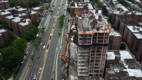 New-high-rise-construction,-development-on-Queens-Blvd,-in-cloudy-NY---Aerial-view