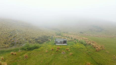 Aerial-view-of-a-remote-hikers-hutment-with-low,-thick-fog