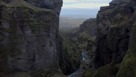 Slow-aerial-shot-through-deep-steep-valley-Múlagljúfur-Canyon-Iceland