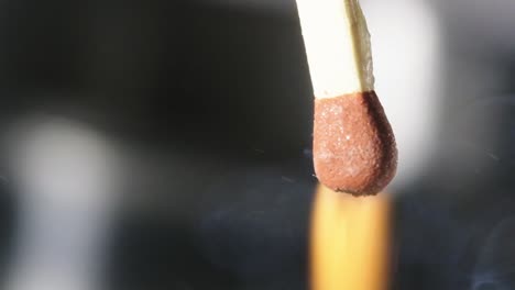 Slow-motion-shot-follow-Match-head-igniting-after-friction-in-Matchbox,-Macro-shot