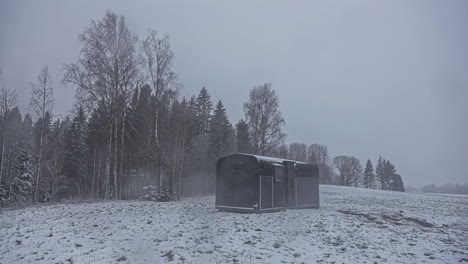 Time-lapse-of-steel-cabin-or-small-house-in-the-middle-of-snowfall