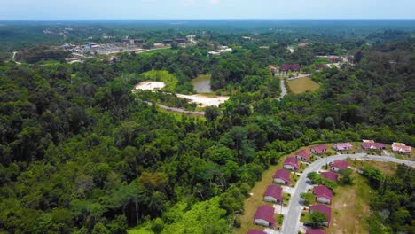 Erstaunliche-Filmische-4k-Drohnenaufnahmen-Von-Wohngebäuden-Nach-Dem-Problem-Der-Entwaldung-Bestehen-Aus-Vielen-Häusern,-Straßen,-Bäumen,-Seen-Und-Infrastruktur-Inmitten-Des-Tropischen-Waldes-In-Riau,-Indonesien