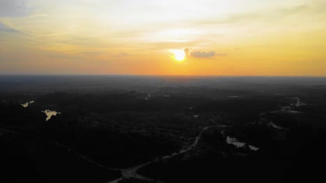 Amazing-cinematic-4K-sunset-residential-drone-footage-after-deforestation-issue-consists-of-homes,-road,-trees,-lake-and-infrastructure-in-the-middle-of-tropical-forest-located-in-Riau,-Indonesia