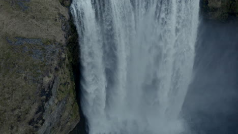 Slow-descending-aerial-shot-over-powerful-Skógafoss-Waterfall-iceland