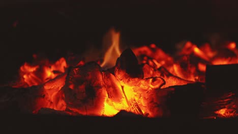 Close-up-macro-shot-of-wood-logs-burning-on-fire-in-outdoor-nature