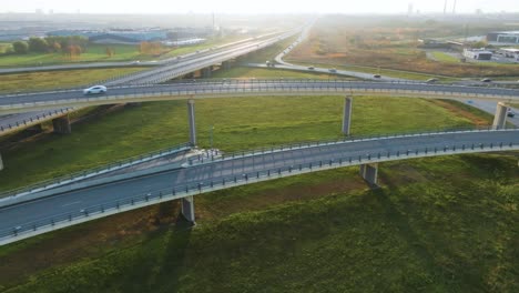An-aerial-view-of-a-country-highway-with-bridges-on-which-cars-drive-in-the-sunny-evening-no-traffic