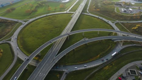 An-aerial-view-a-large-roundabout-on-the-outskirts-of-the-city-with-several-bridges-for-cars-and-trucks
