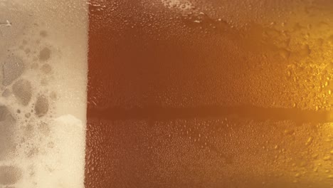 a-spinning-fresh-pint-of-beer-with-generous-froth-on-its-side-in-a-close-up-shot