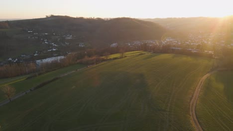 Golden-hour-light-illuminating-fields-and-a-small-German-village-in-a-valley
