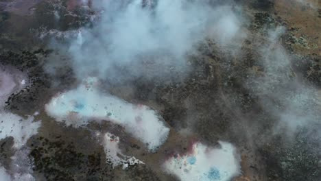 White-silica-mud-pools-at-geothermal-active-landscape,-aerial