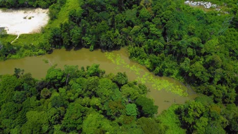 Amazing-cinematic-4K-residential-drone-footage-after-deforestation-issue-consists-of-many-homes,-road,-trees,-lake-and-infrastructure-in-the-middle-of-tropical-forest-located-in-Riau,-Indonesia